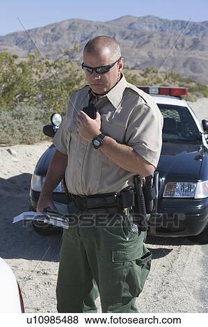 POlice officer on two-way radio View Large Photo Image Stock Photo - POlice officer on two-way radio. Fotosearch