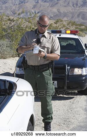 Police officer takes car details View Large Photo Image Stock Photo - Police officer takes car details. Fotosearch