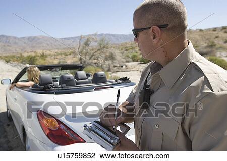 Police officer writing a ticket for a convertible driver View Large Photo Image Stock Image - Police officer writing a ticket for a convertible driver. Fotosearch