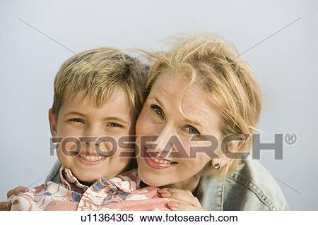 Portrait of mother embracing son outdoors View Large Photo Image Stock Photography - Portrait of mother embracing son outdoors. Fotosearch