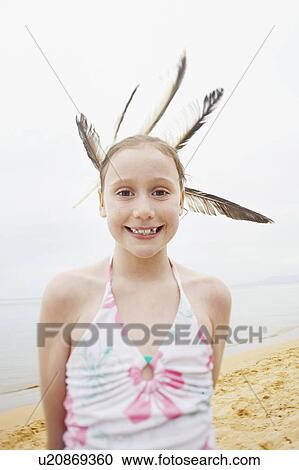 Pre-teen girl standing on beach with feathers in hair, portrait View Large Photo Image Stock Image - Pre-teen girl standing on beach with feathers in hair, portrait. Fotosearch