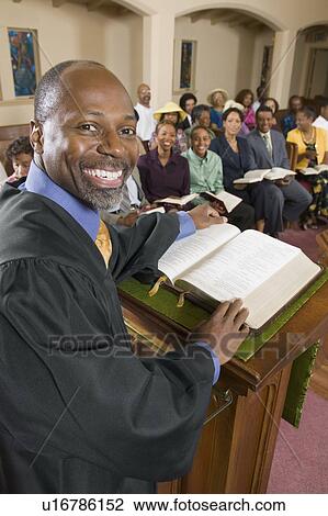 Preacher at altar with Bible preaching to Congregation, portrait View Large Photo Image Stock Image - Preacher at altar with Bible preaching to Congregation, portrait. Fotosearch