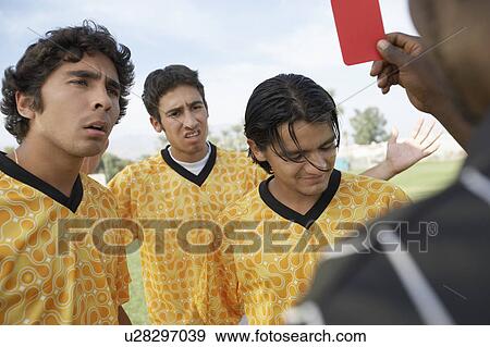 Stock Photo - Referee holding out red card, dismissing player. Fotosearch