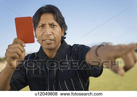Referee holding up red card and pointing, portrait View Large Photo Image Stock Photo - Referee holding up red card and pointing, portrait. Fotosearch
