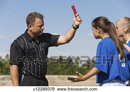 Referee showing red card to girls (13-17) playing soccer View Large Photo Image Stock Photo - Referee showing red card to girls (13-17) playing soccer. Fotosearch