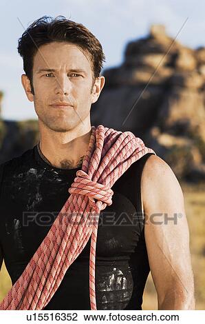 Stock Image - Rock climber with Rope on Shoulder, (portrait). Fotosearch