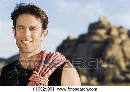 Stock Image - Rock climber with Rope on Shoulder, (portrait). Fotosearch