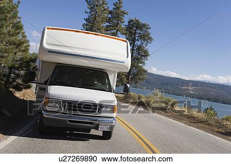 Stock Image - RV driving on mountain road. Fotosearch