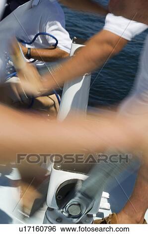 Sailors operating windlass on yacht, close up of arms View Large Photo Image Stock Photograph - Sailors operating windlass on yacht, close up of arms. Fotosearch