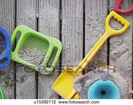 Sand pit toys lying on wooden deck, view from above View Large Photo Image Stock Image - Sand pit toys lying on wooden deck, view from above. Fotosearch