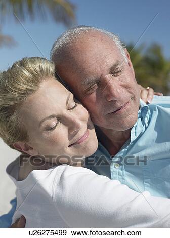 Senior couple cheek to cheek on tropical beach, close up View Large Photo Image Stock Photo - Senior couple cheek to cheek on tropical beach, close up. Fotosearch