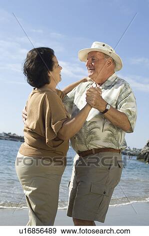Stock Photo - Senior couple dancing on beach. Fotosearch