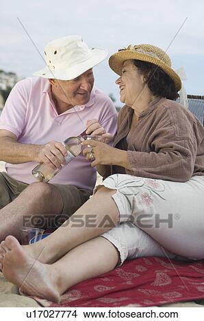 Senior couple drinking wine and looking in eyes View Large Photo Image Picture - Senior couple drinking wine and looking in eyes. Fotosearch
