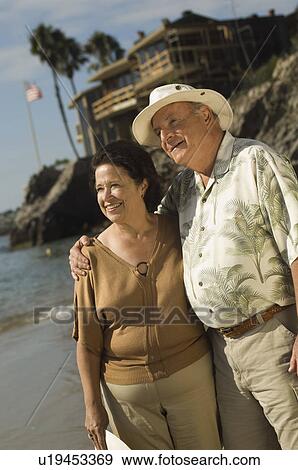 Stock Photo - Senior couple embracing at ocean. Fotosearch