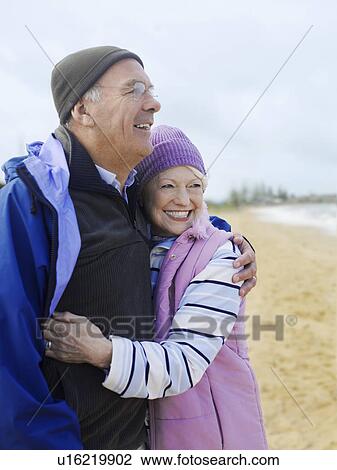 Stock Image - Senior couple embracing outdoors. Fotosearch