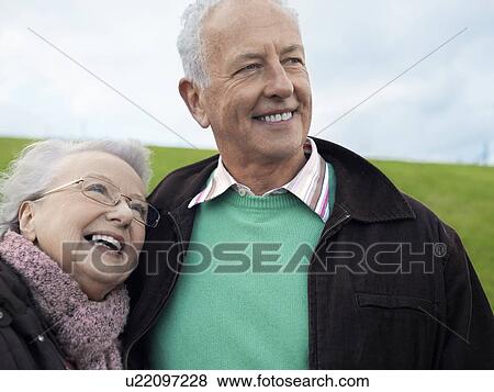 Stock Photo - Senior couple embracing outdoors. Fotosearch