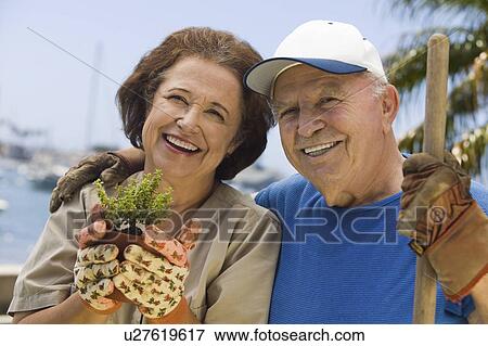 Stock Photo - Senior couple gardening, (portrait). Fotosearch