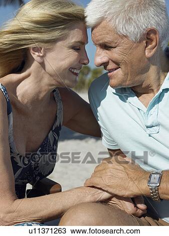 Senior couple holding hands on tropical beach, close up View Large Photo Image Stock Image - Senior couple holding hands on tropical beach, close up. Fotosearch