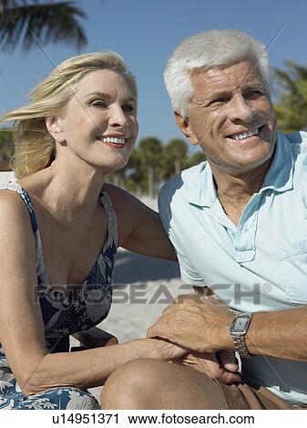 Senior couple holding hands on tropical beach View Large Photo Image Stock Image - Senior couple holding hands on tropical beach. Fotosearch