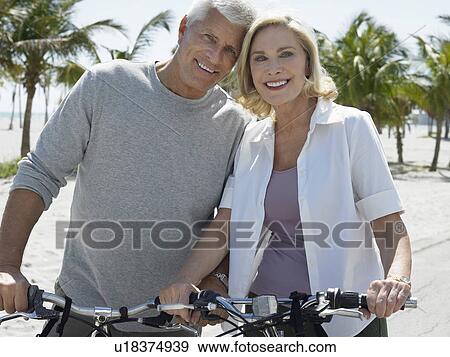 Senior couple on bicycles on tropical beach View Large Photo Image Stock Photo - Senior couple on bicycles on tropical beach. Fotosearch