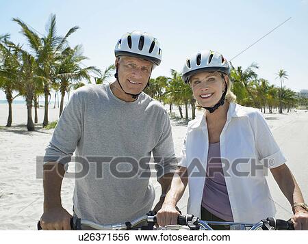 Senior couple on bicycles on tropical beach View Large Photo Image Stock Photograph - Senior couple on bicycles on tropical beach. Fotosearch