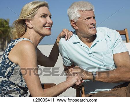 Senior couple on sunloungers on tropical beach, close up View Large Photo Image Stock Image - Senior couple on sunloungers on tropical beach, close up. Fotosearch