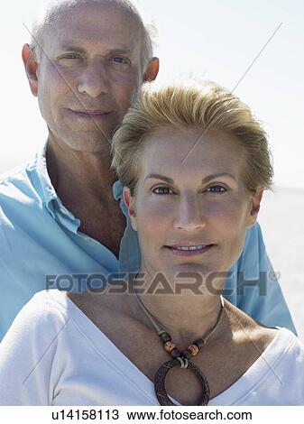 Stock Image - Senior couple on tropical beach, close up. Fotosearch