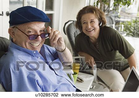Senior couple relaxing on porch View Large Photo Image Stock Image - Senior couple relaxing on porch. Fotosearch