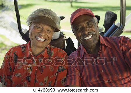 Senior couple sitting in golf cart, smiling, (portrait) View Large Photo Image Stock Image - Senior couple sitting in golf cart, smiling, (portrait). Fotosearch
