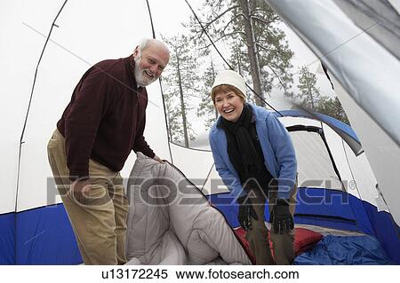Senior couple standing inside tent, (portrait) View Large Photo Image Stock Photography - Senior couple standing inside tent, (portrait). Fotosearch