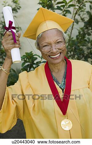 Senior graduate hoisting diploma outside, portrait View Large Photo Image Stock Image - Senior graduate hoisting diploma outside, portrait. Fotosearch