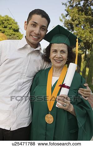 Stock Photo - Senior Graduate with son outside, portrait. Fotosearch