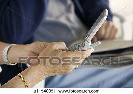 Senior woman using mobile phone, (close-up) View Large Photo Image Stock Image - Senior woman using mobile phone, (close-up). Fotosearch