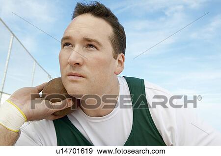 Stock Photo - Shot Putter holding shot put, head and shoulders. Fotosearch