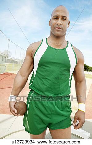 Picture - Shot Putter holding shot put, half-length. Fotosearch