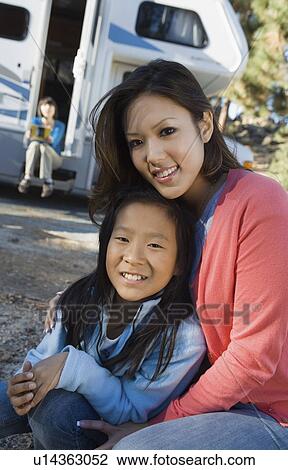 Sisters sitting outside RV in campground View Large Photo Image Stock Image - Sisters sitting outside RV in campground. Fotosearch
