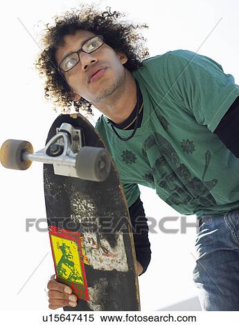 Skateboarder outdoors, low angle view View Large Photo Image Stock Photography - Skateboarder outdoors, low angle view. Fotosearch