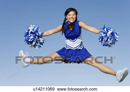 Smiling Cheerleader jumping in mid-air, (portrait) View Large Photo Image Stock Photo - Smiling Cheerleader jumping in mid-air, (portrait). Fotosearch