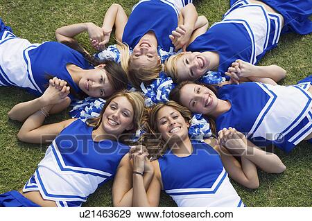 Smiling Cheerleaders lying in circle on lawn, (portrait), (elevated view) View Large Photo Image Stock Photo - Smiling Cheerleaders lying in circle on lawn, (portrait), (elevated view). Fotosearch