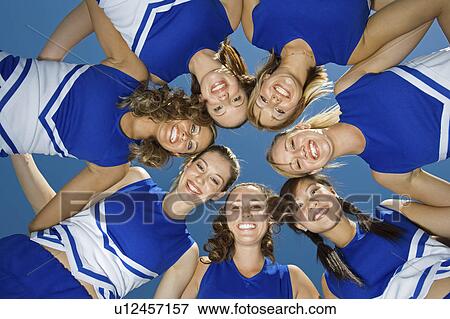 Smiling Cheerleaders standing in circle, (portrait), (view from below) View Large Photo Image Stock Photo - Smiling Cheerleaders standing in circle, (portrait), (view from below). Fotosearch
