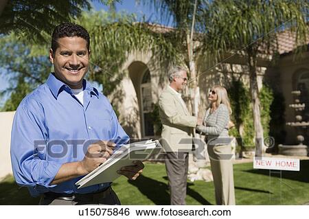 Smiling estate agent, portrait View Large Photo Image Stock Photograph - Smiling estate agent, portrait. Fotosearch