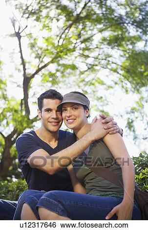 Stock Photograph - Smiling young couple, portrait. Fotosearch