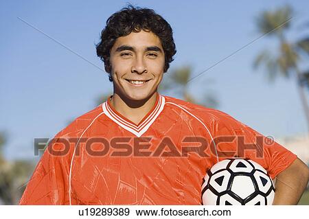 Soccer player holding ball, portrait View Large Photo Image Stock Photo - Soccer player holding ball, portrait. Fotosearch