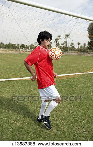 Soccer player juggling ball, portrait View Large Photo Image Stock Photo - Soccer player juggling ball, portrait. Fotosearch