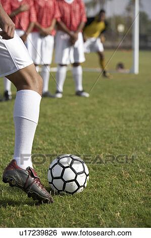 Soccer player taking free kick, low section View Large Photo Image Stock Photograph - Soccer player taking free kick, low section. Fotosearch
