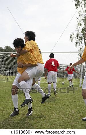 Soccer players celebrating goal, portrait View Large Photo Image Stock Photo - Soccer players celebrating goal, portrait. Fotosearch