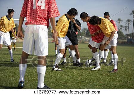 Stock Photo - Soccer players competing for ball. Fotosearch