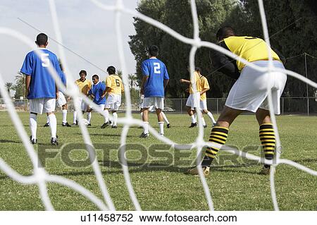 Stock Image - Soccer Players Competing for the Ball. Fotosearch