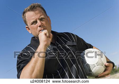 Soccer referee blowing whistle, portrait View Large Photo Image Picture - Soccer referee blowing whistle, portrait. Fotosearch