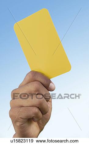 Soccer referee holding up yellow card, close-up on hand View Large Photo Image Stock Photo - Soccer referee holding up yellow card, close-up on hand. Fotosearch